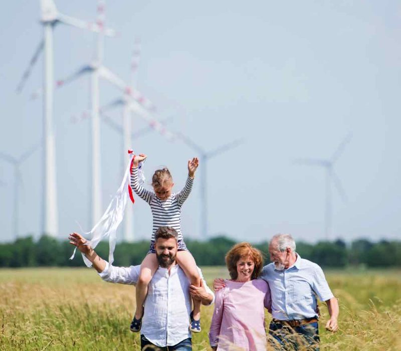 multigeneration-family-walking-on-field-on-wind-fa-AMW3XD9.jpg